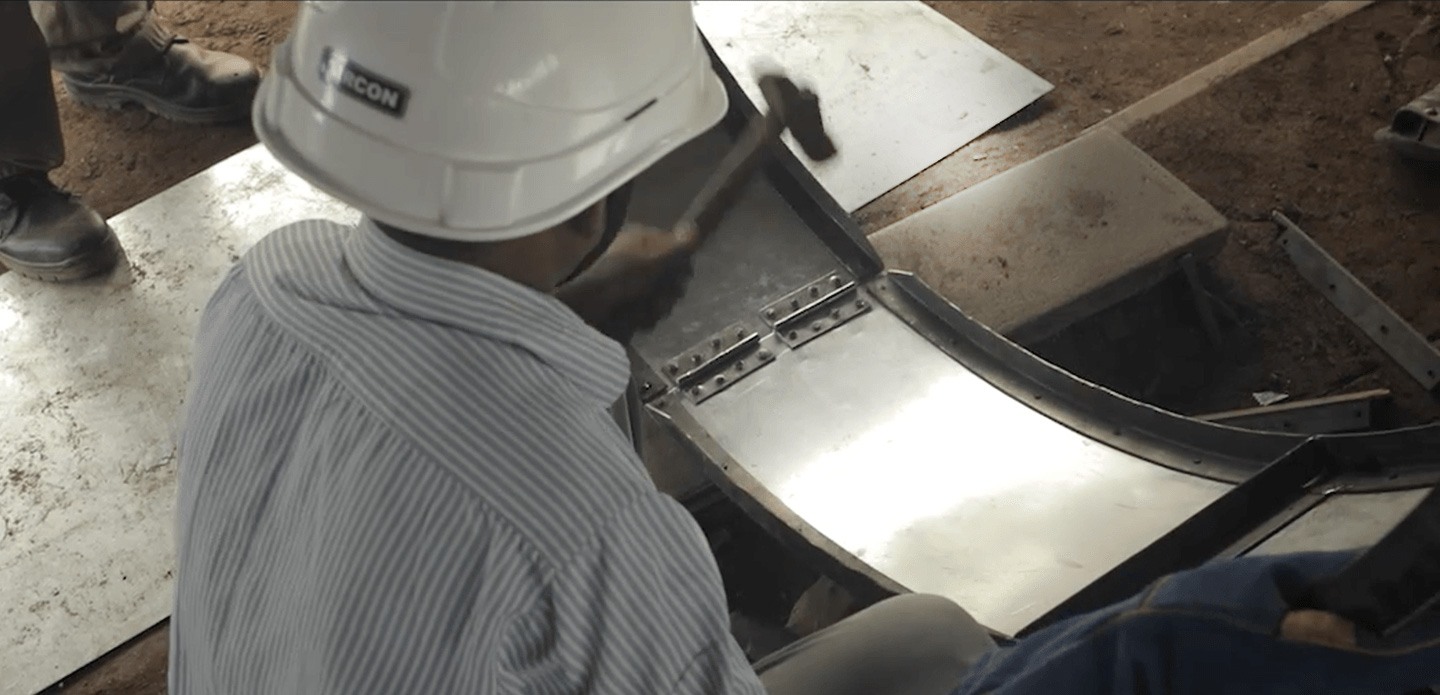 Worker building a biodigester